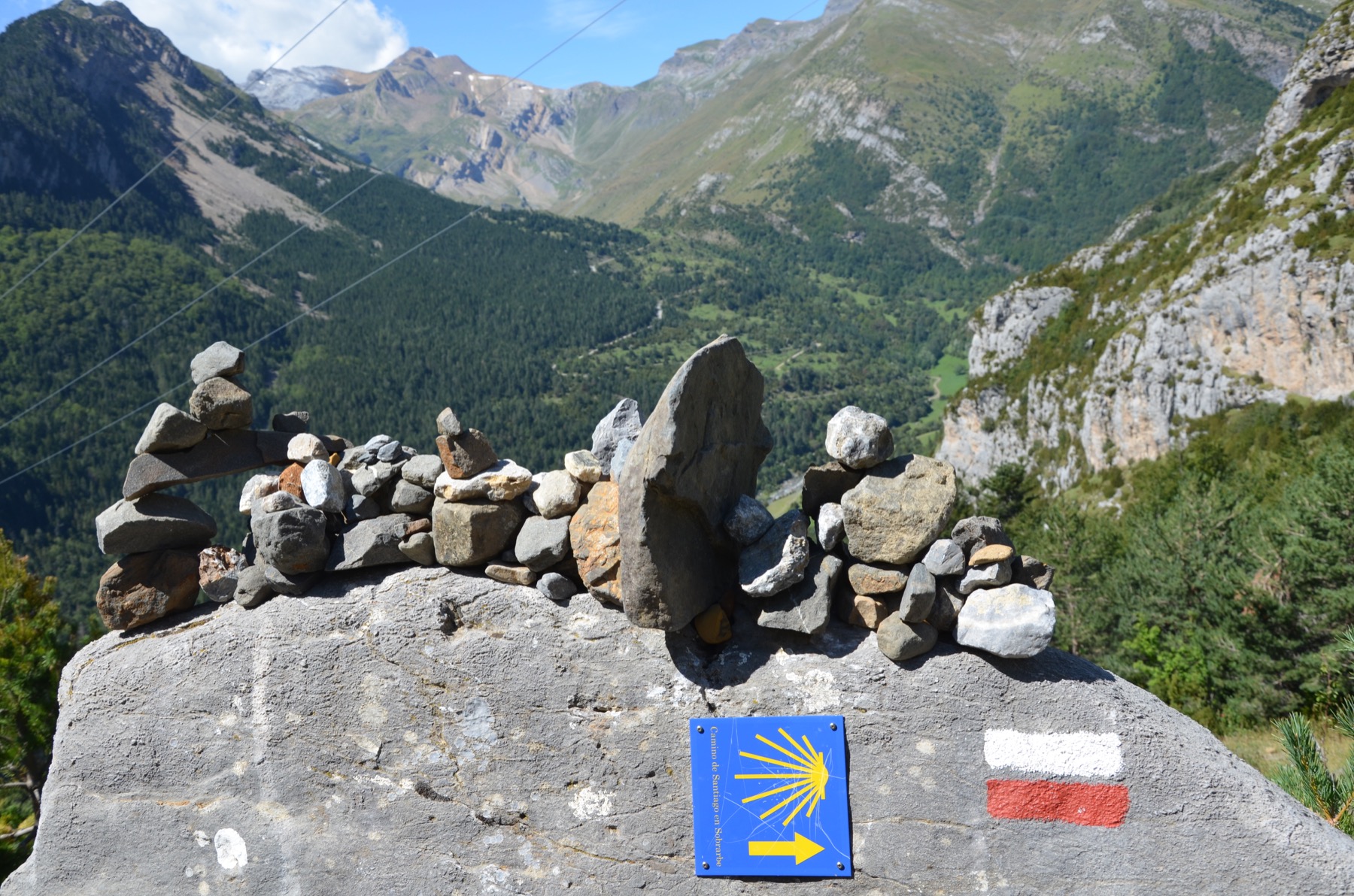 Camino waymark and cairns above the Bujaruelo valley on the Way of Saint James in Aragon