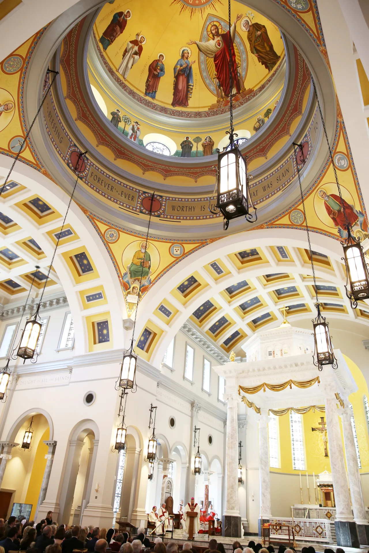 The Sacred Heart of Jesus in the cathedral dome above an Evangelist pendentive and the sanctuary.