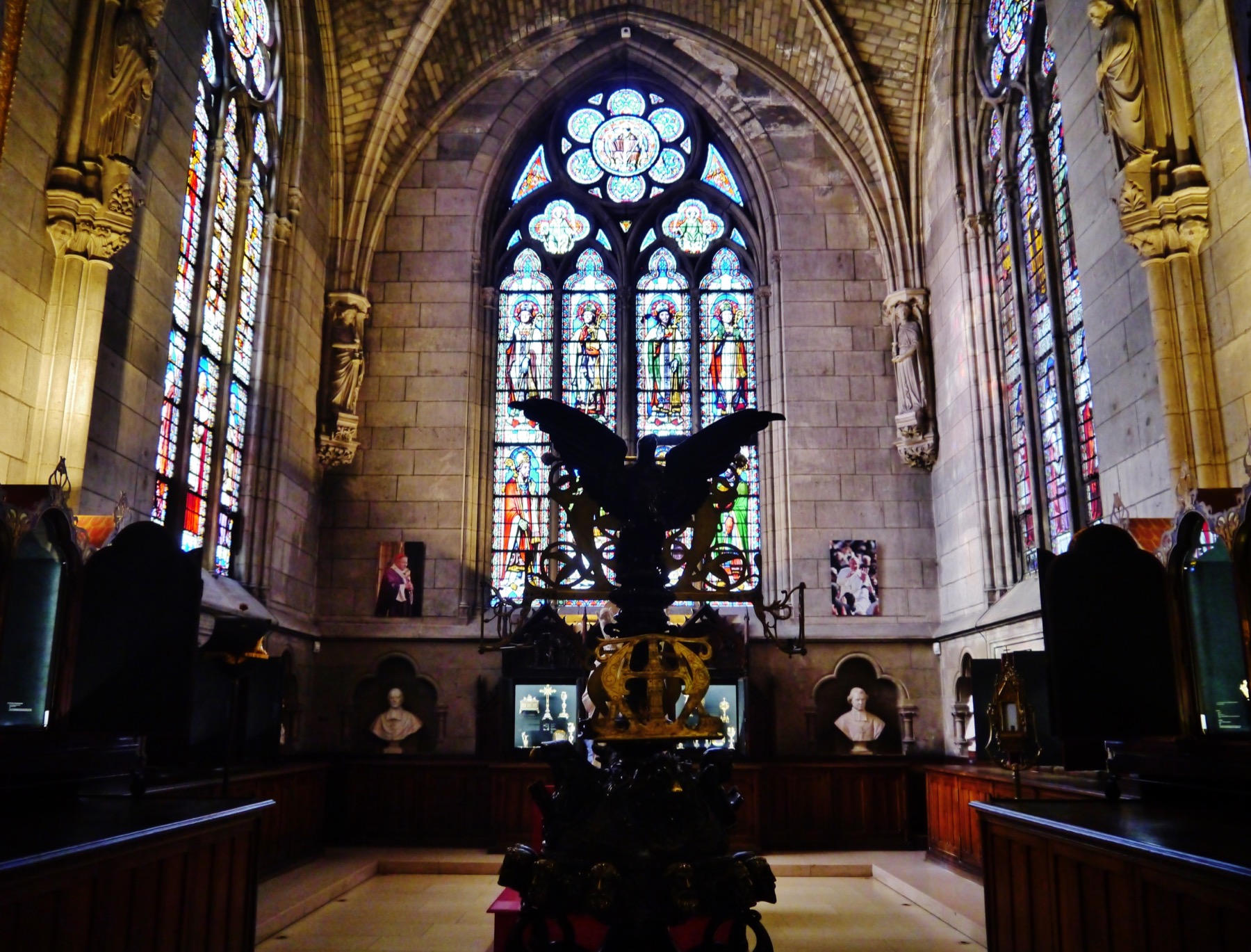 The Treasury of Notre-Dame Cathedral in Paris with stained glass and devotional objects.