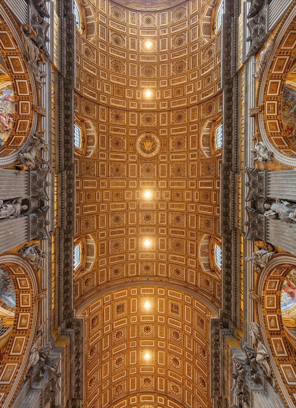 The gilded coffered vault of St. Peter's Basilica receding above the nave.