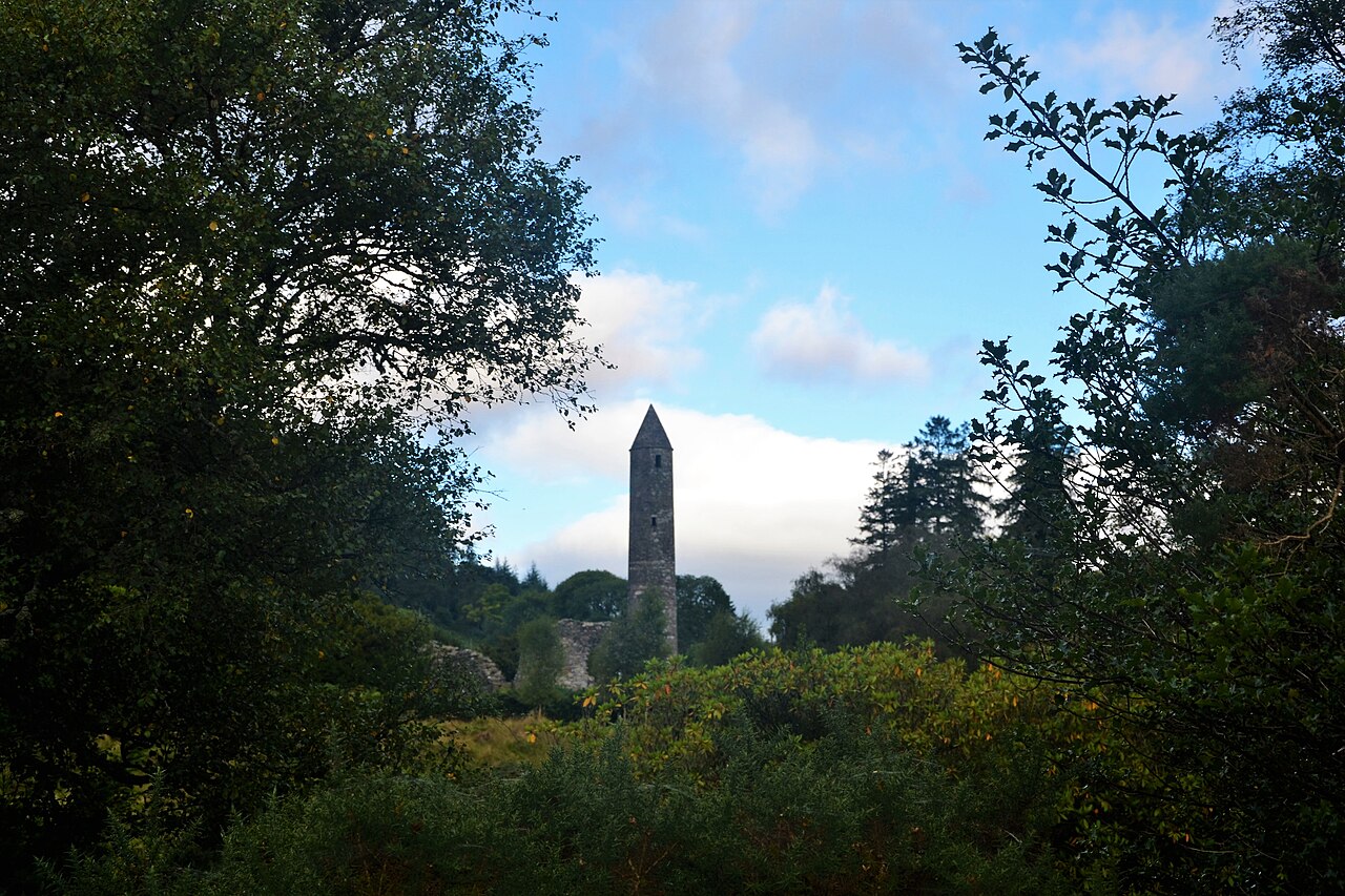 The round tower rising above the graves and churches of the Monastic City at Glendalough.