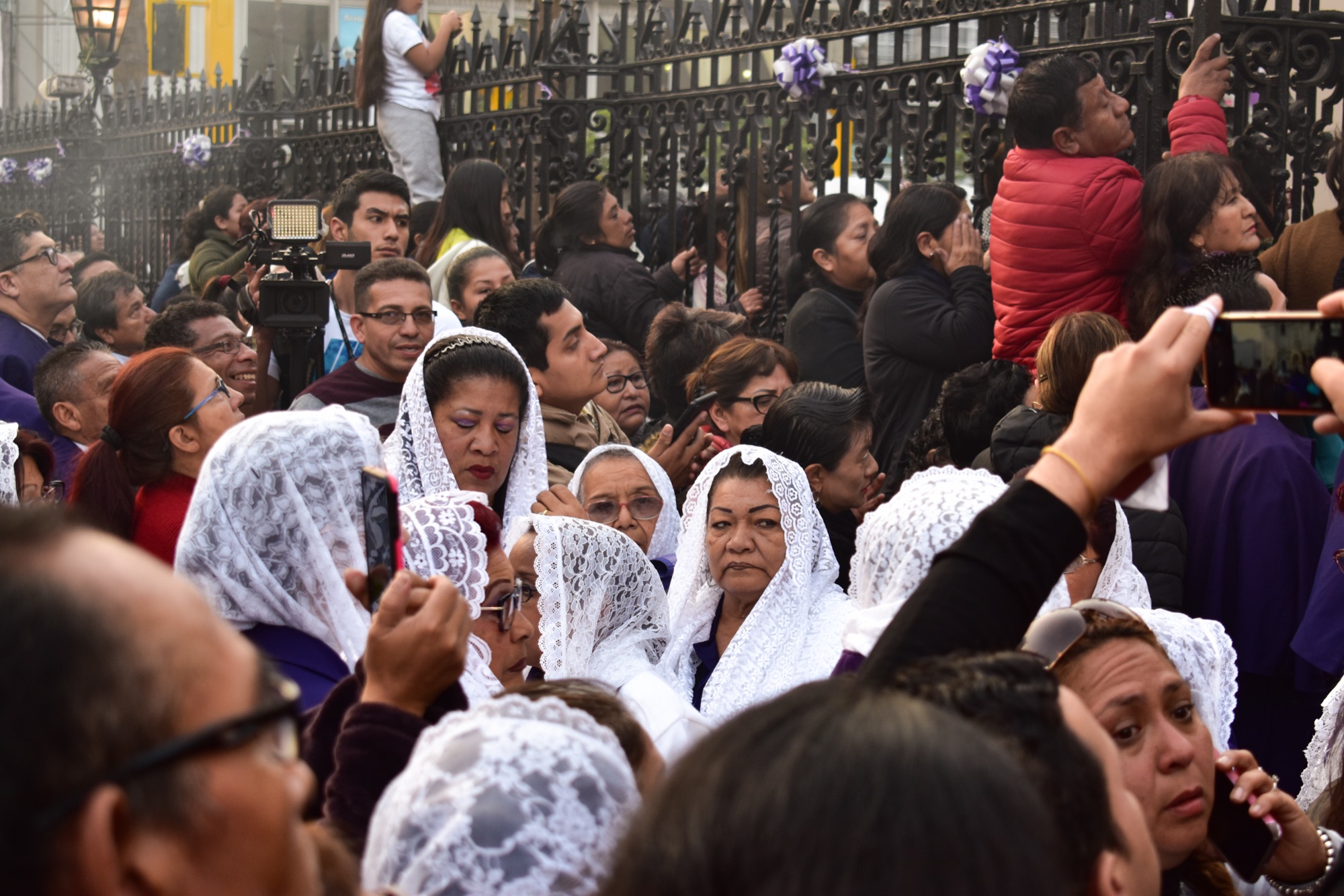 Women of the incense guild walking in the October procession of the Lord of Miracles in Lima.
