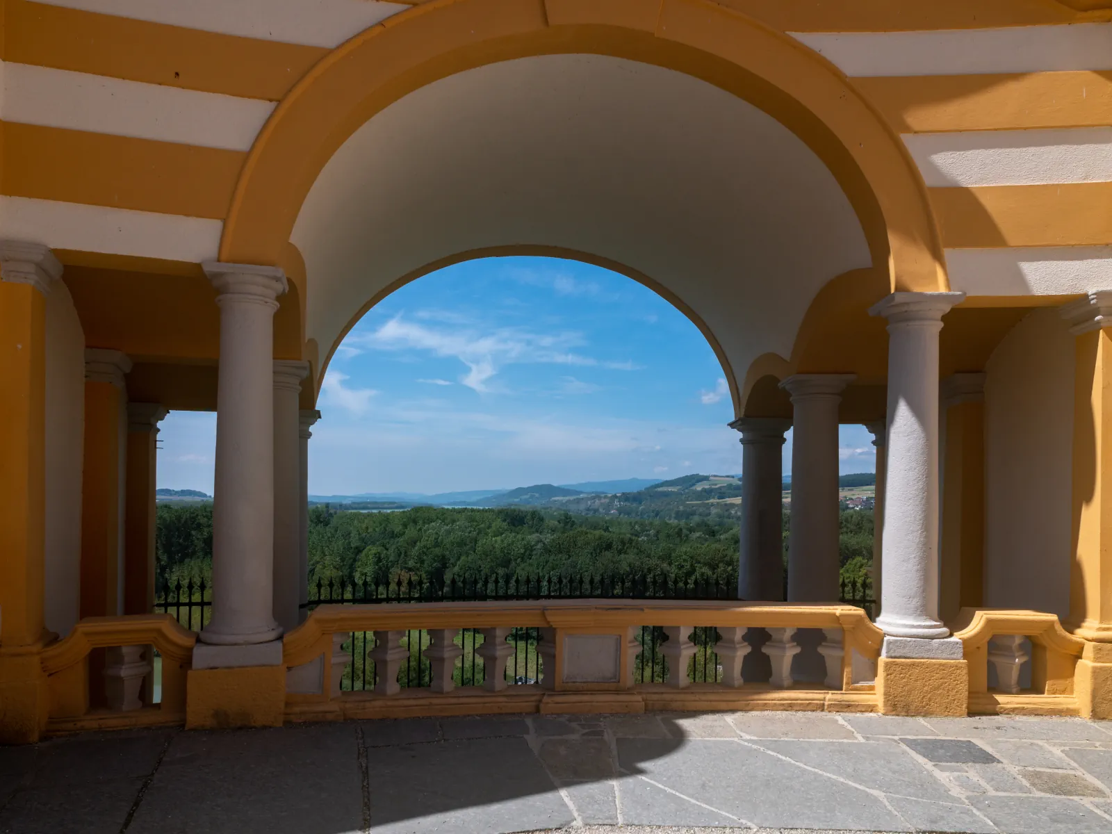 View through the Altane terrace of Melk Abbey toward the Danube landscape.