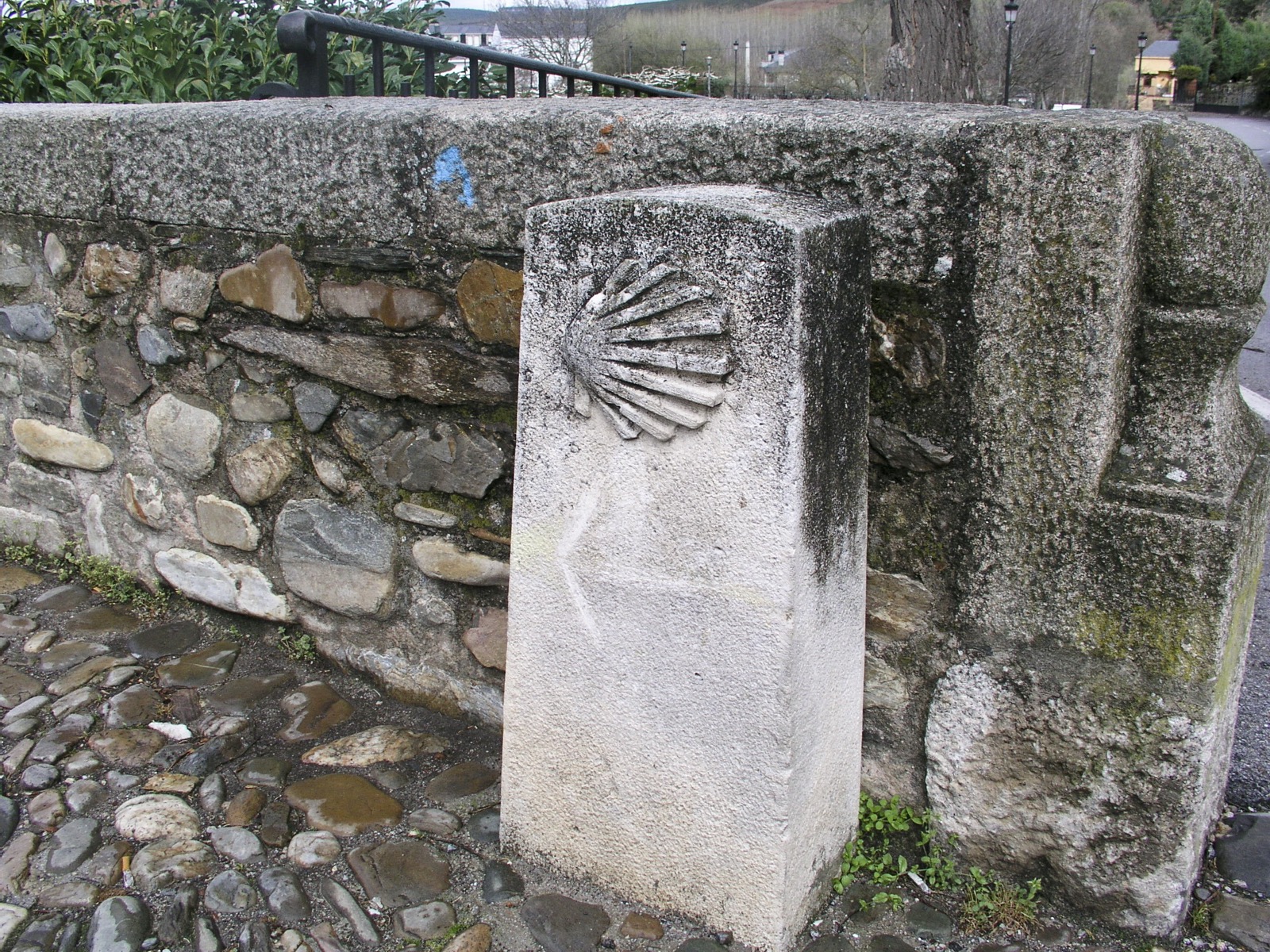 Stone Way of Saint James marker with a scallop shell in Molinaseca