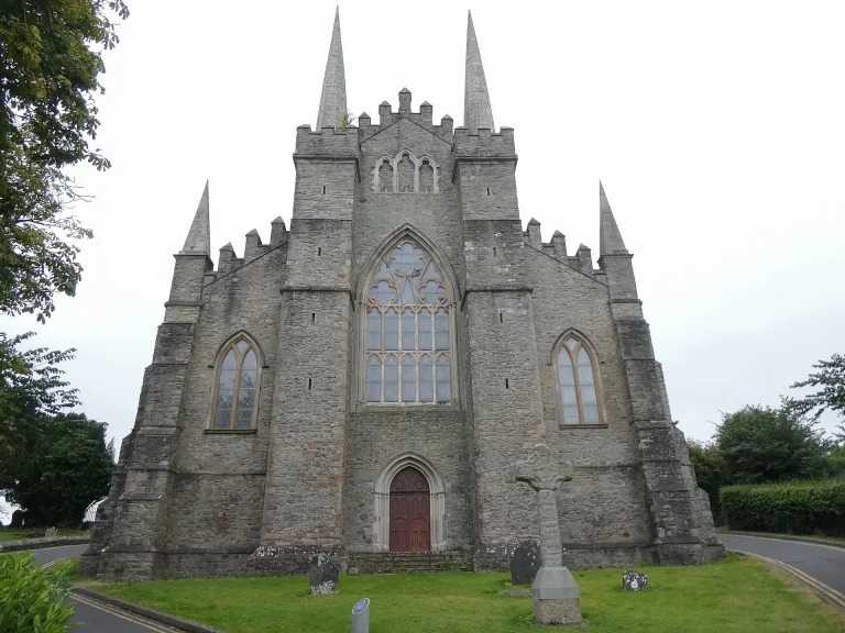 Down Cathedral on the green Cathedral Hill above Downpatrick under a blue sky.