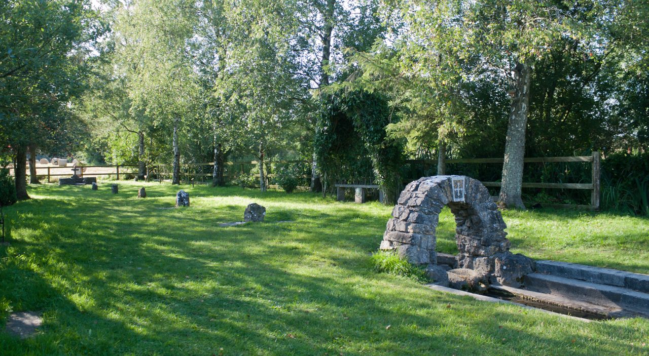 A sequence of stone prayer stations beside the channel at St. Brigid's Well in Kildare.