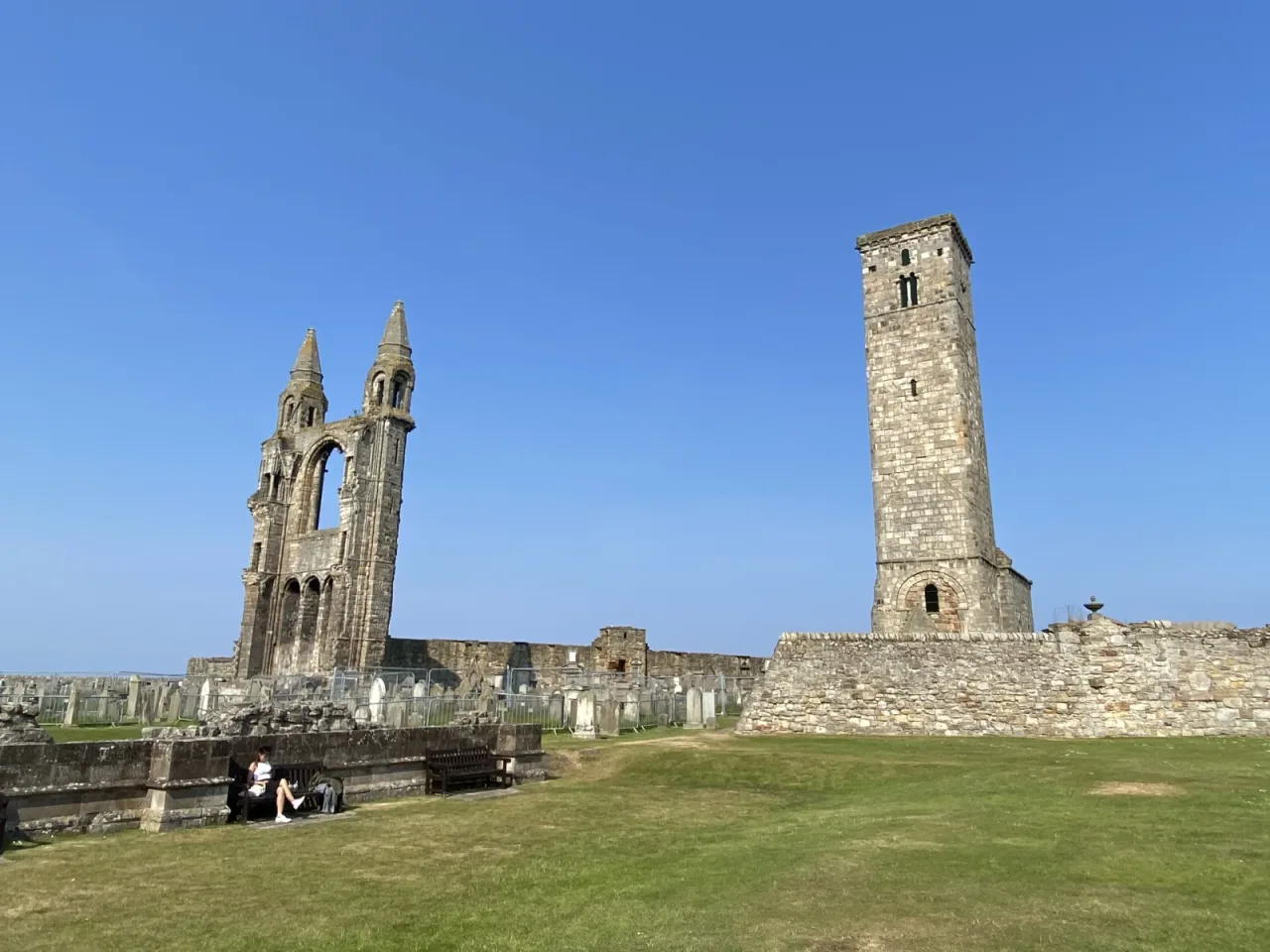 St Rule's Tower and the surviving western turrets seen across the former cathedral courtyard under a clear sky.