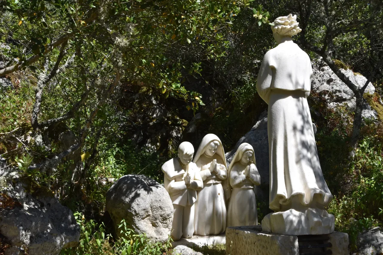 The Angel of Peace and the three shepherd children carved in stone among the rocks and olives of the Loca do Cabeco at Valinhos.