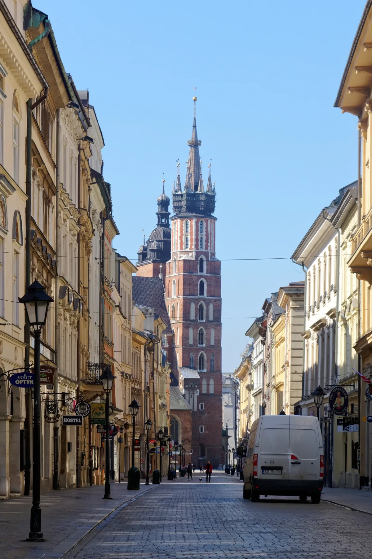 Ulica Floriańska in Kraków looking south over cobbles toward the taller tower of St. Mary's Basilica.