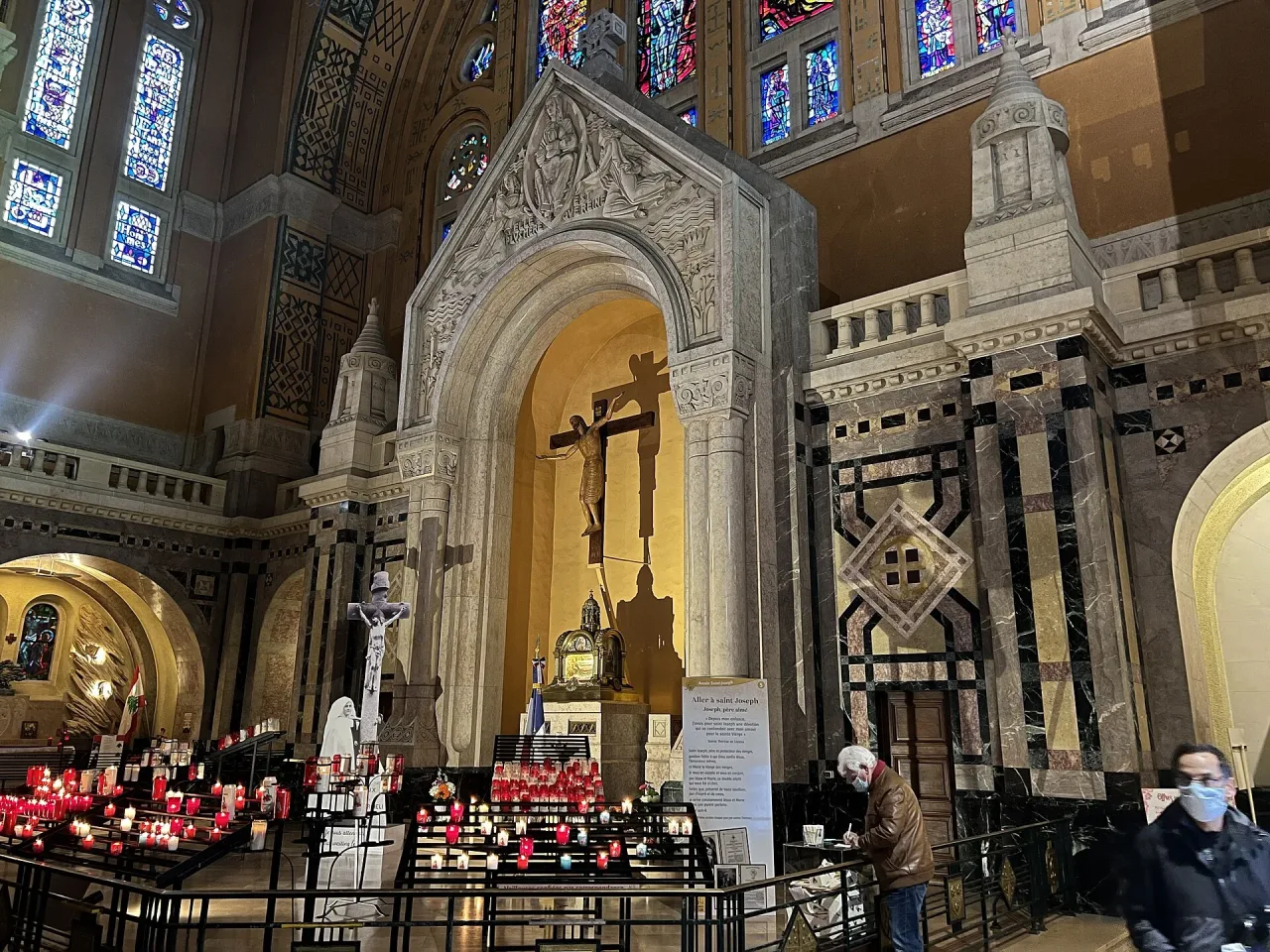 The interior of the Basilica of Sainte-Thérèse in Lisieux, its mosaic-covered walls and arches rising above the nave toward the sanctuary.