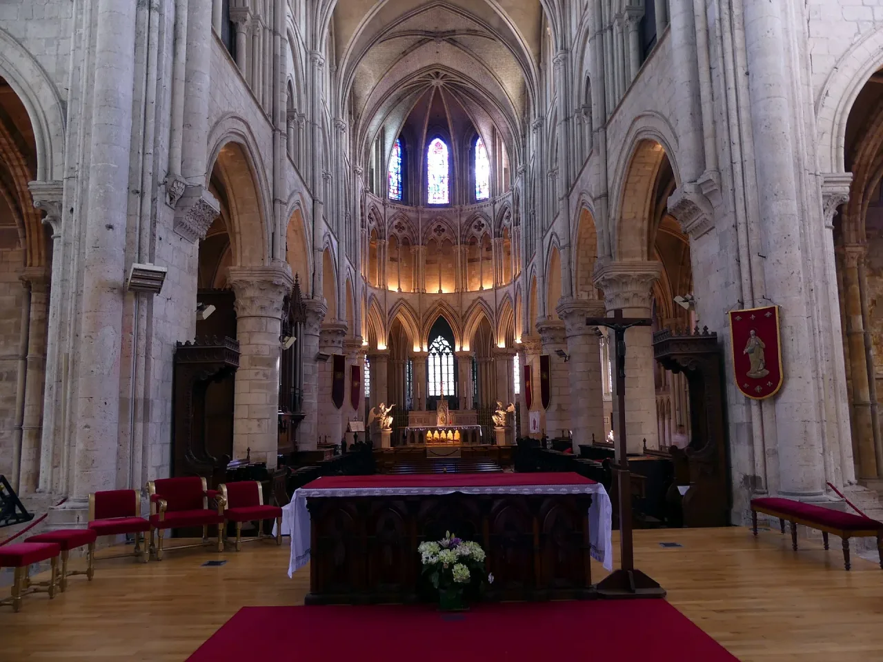 The nave of the Cathedral of Saint-Pierre in Lisieux seen from the choir, its pale Norman Gothic arcades running west.