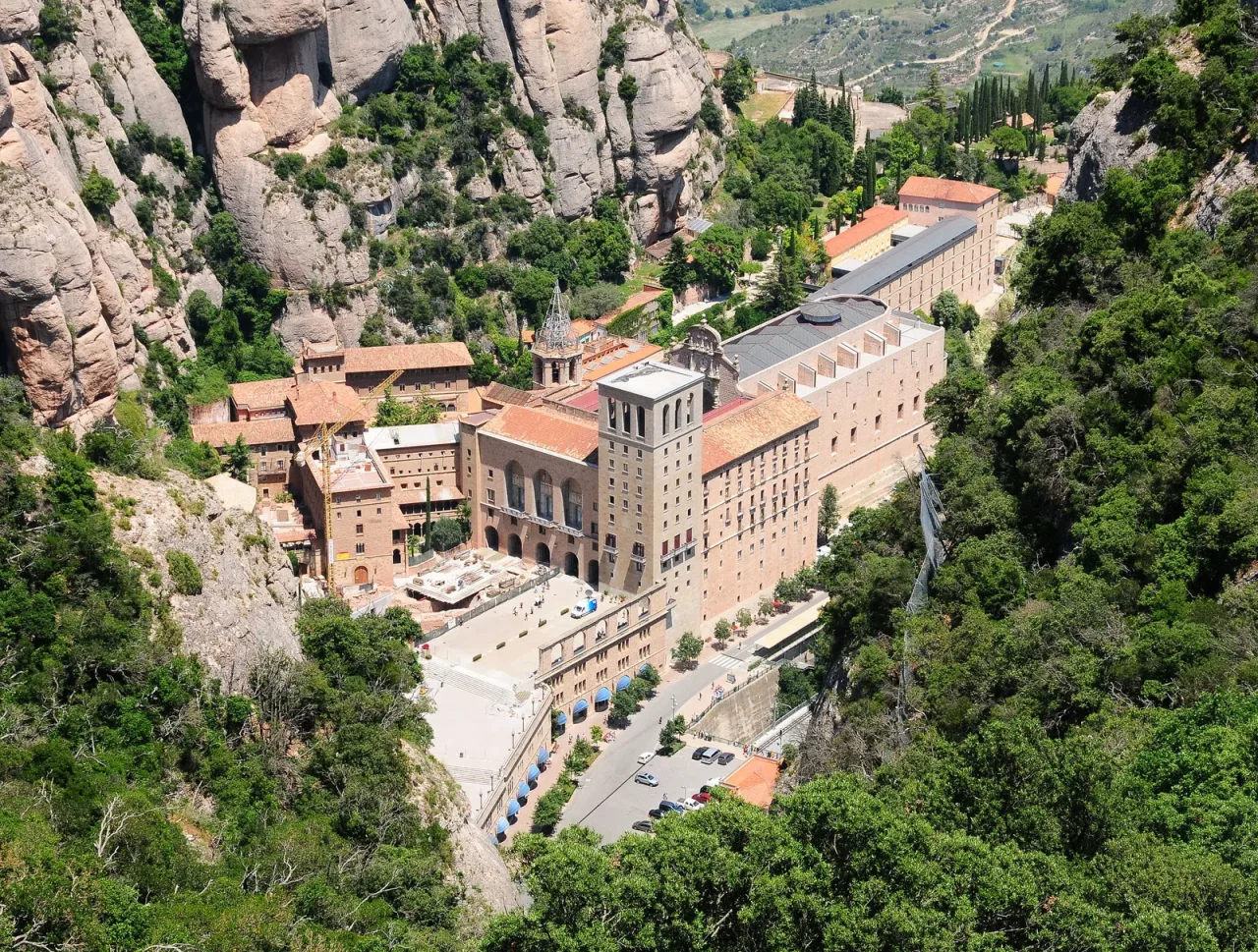 The Benedictine abbey and basilica of Santa Maria de Montserrat set against the serrated rock of the Montserrat massif.