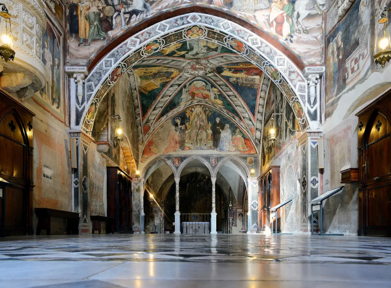 The frescoed medieval upper church of the Sacro Speco at Subiaco, its vaults and walls painted from floor to ceiling.