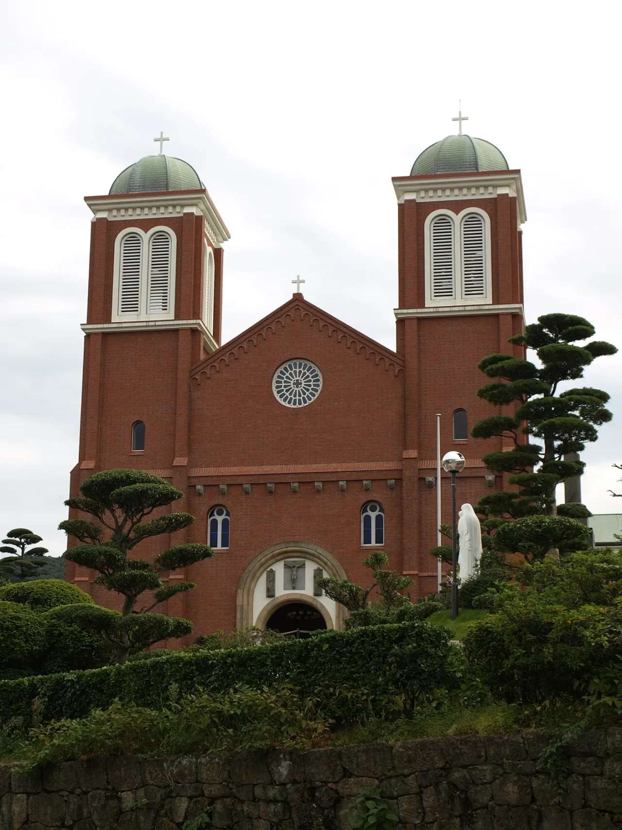 The twin towers and rose window of Urakami Cathedral seen from the road below.