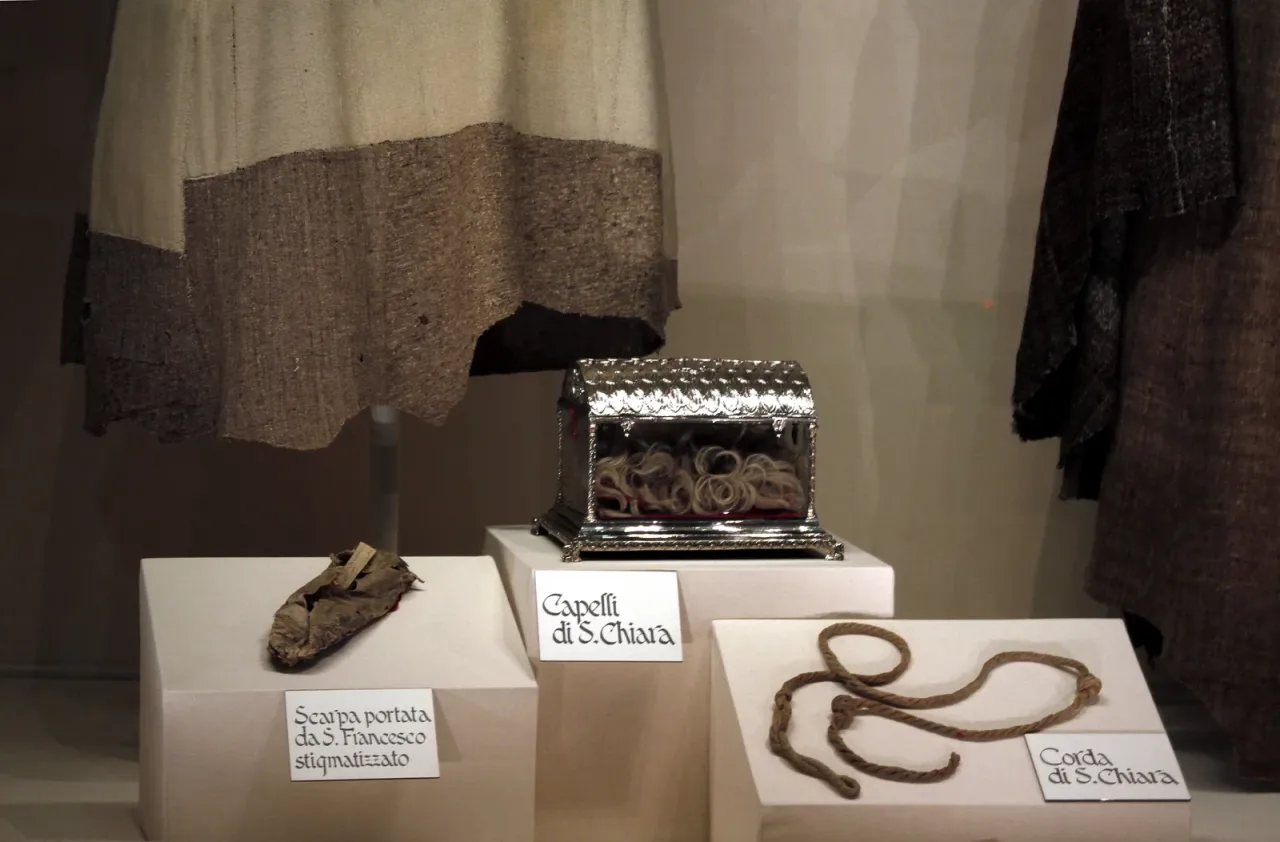 Relics of Saint Clare displayed in the Basilica di Santa Chiara at Assisi: a reliquary of her hair, her knotted cord, and a shoe worn by Saint Francis.