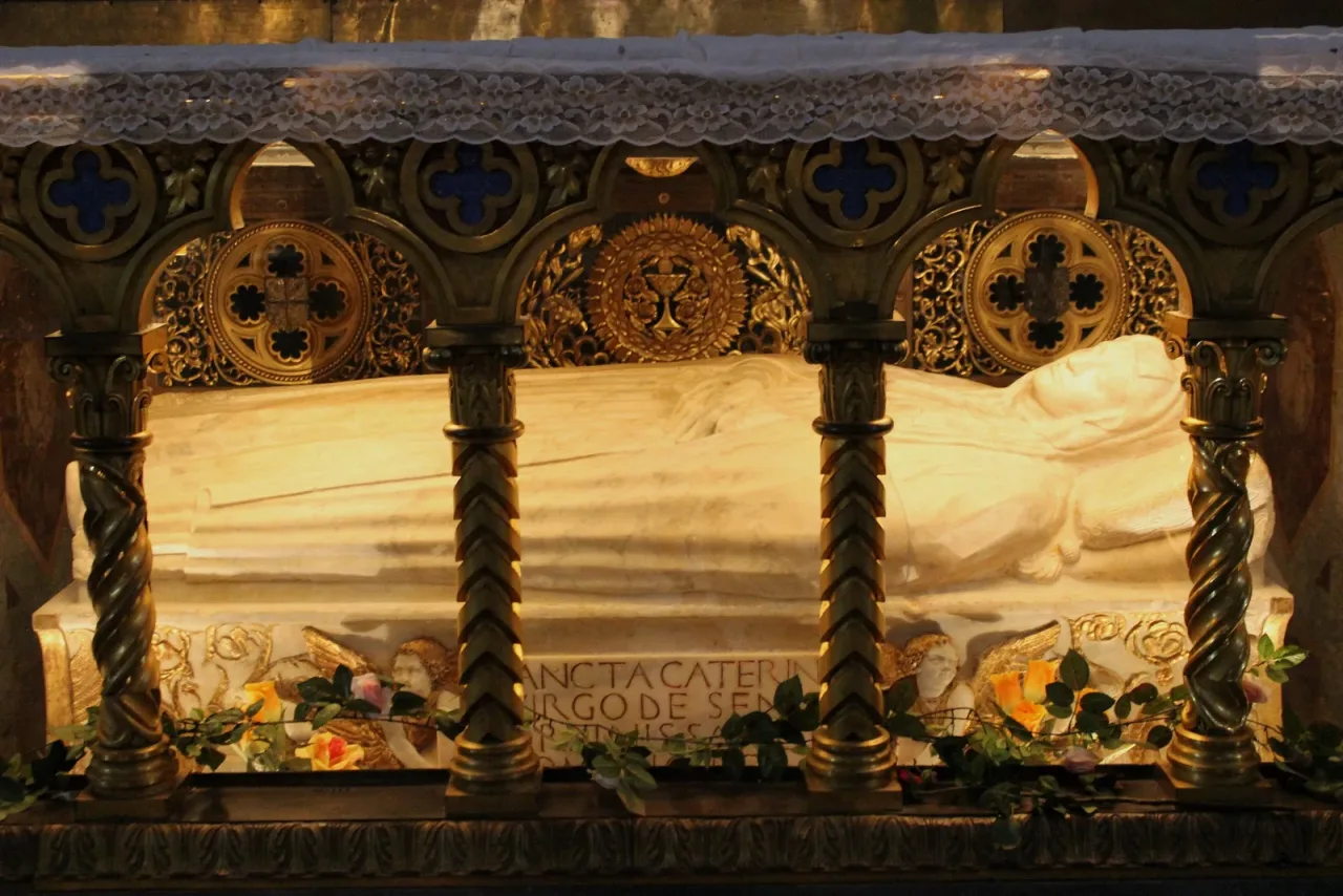 The recumbent marble effigy of Saint Catherine of Siena beneath the high altar of Santa Maria sopra Minerva in Rome.