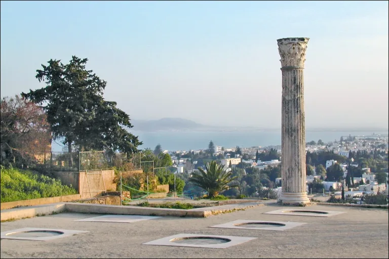 A standing Roman column on the archaeological site of Carthage above the Gulf of Tunis.