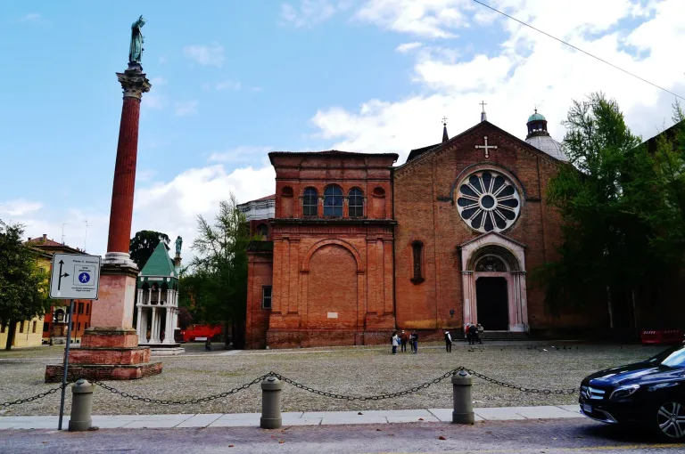 The facade of the Basilica of San Domenico in Bologna with its piazza and column.
