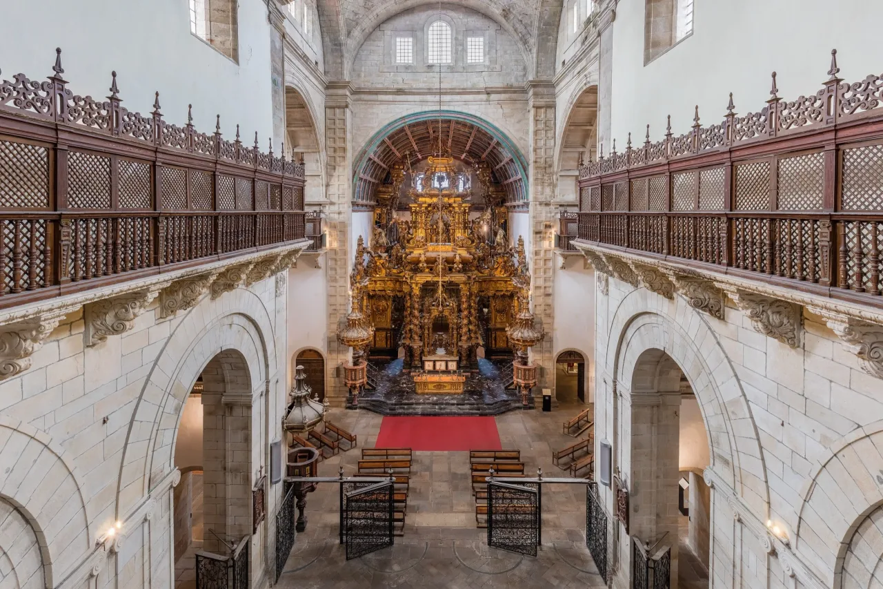 The barrel-vaulted nave of the church of San Martiño Pinario looking toward the gilded Baroque high altarpiece.