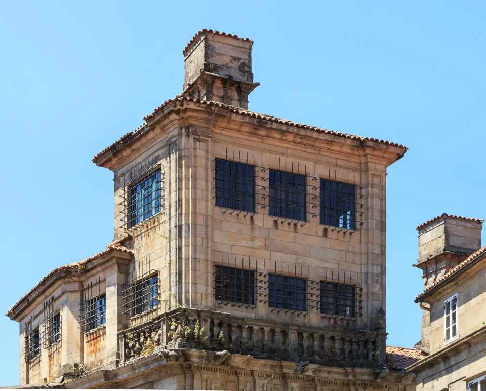 The bell tower of the monastery of San Paio de Antealtares rising above the granite roofs of Santiago de Compostela.
