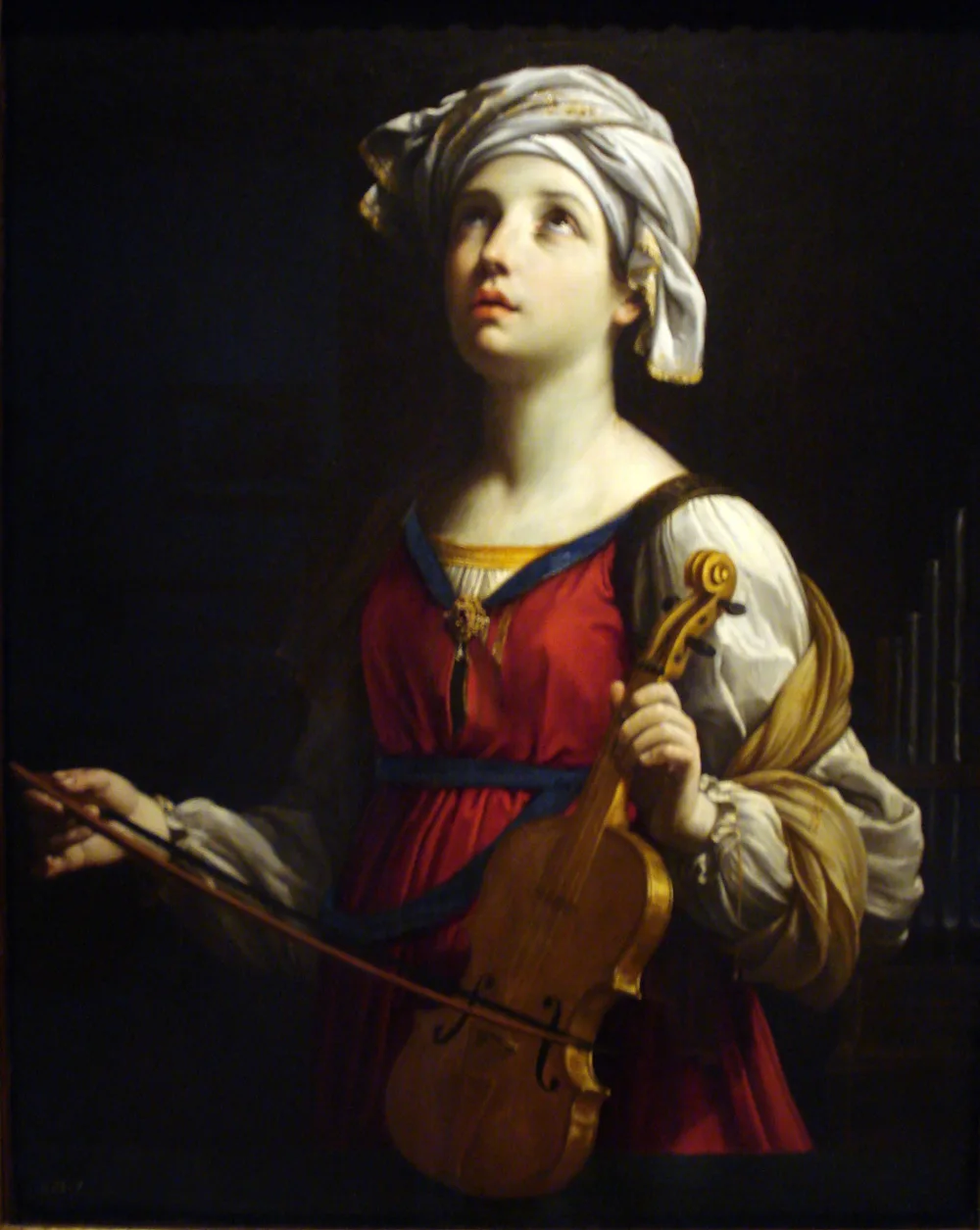 Guido Reni's painting of Saint Cecilia holding a viol and bow, gazing upward, with a small organ at her side